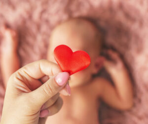 newborn baby and mom's hands. selective focus. people.